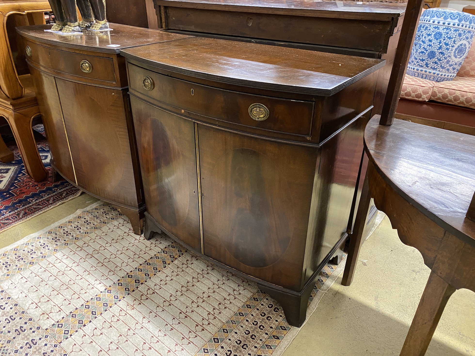 A pair of George III style mahogany bow front side cabinets, width 83cm, depth 50cm, height 86cm